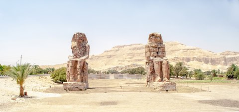 The Colossi of Memnon standing at the entrance to the Theban Necropolis near Luxor, Egypt
