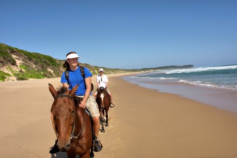 Horse riders on the sandy shoreline of Sodwana Bay on South Africa’s east coast