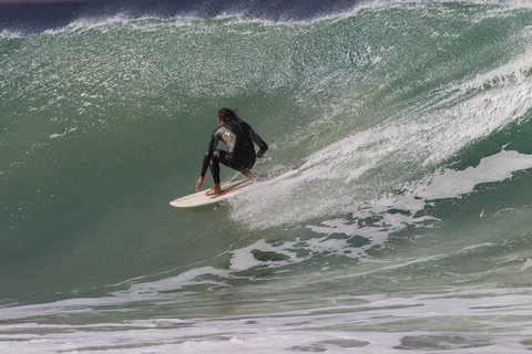 Surfer riding a powerful wave at Super Tubes in Jeffreys Bay, South Africa